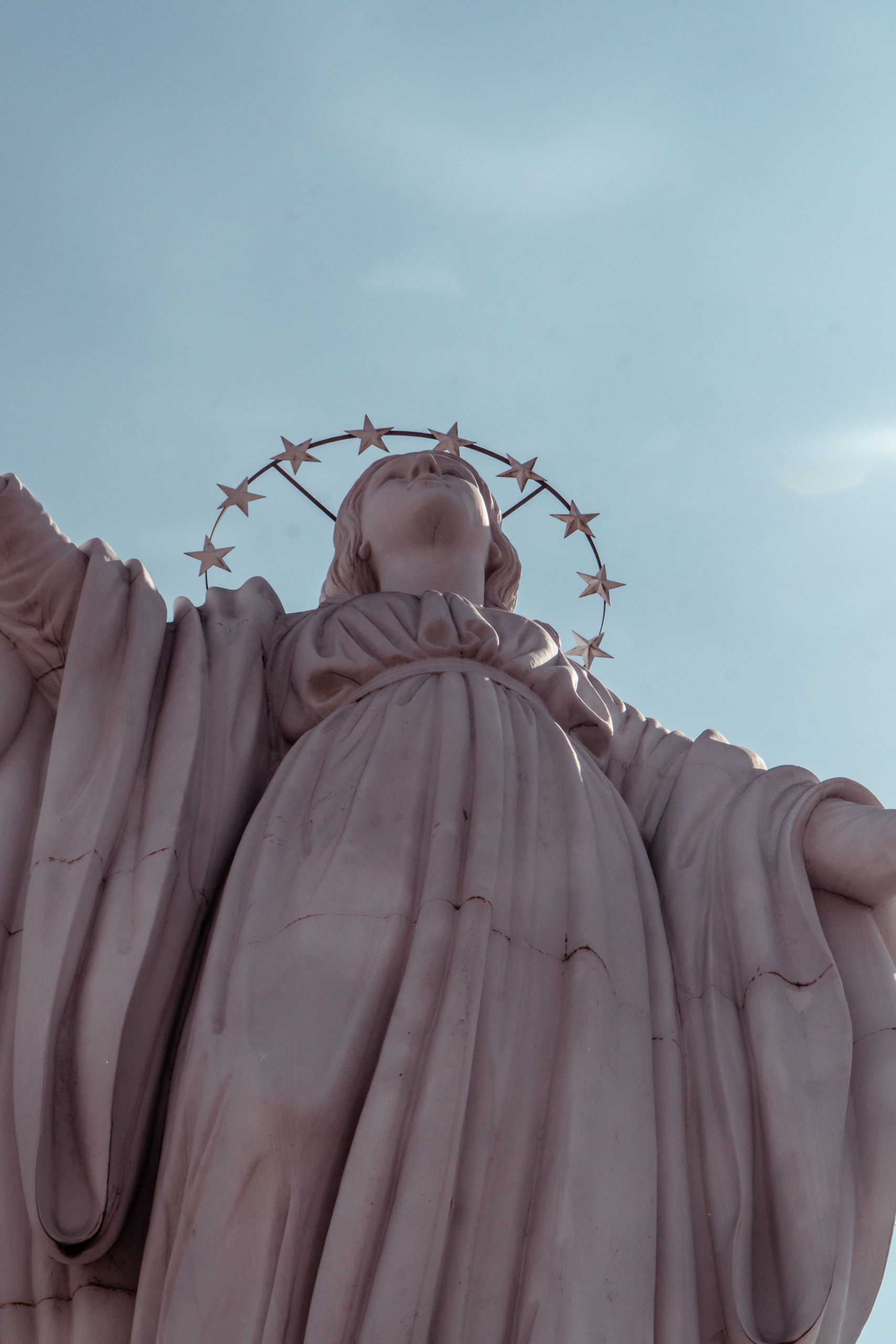 Majestic low-angle view of the Virgin Mary statue at Cerro San Cristóbal, highlighting cultural heritage.